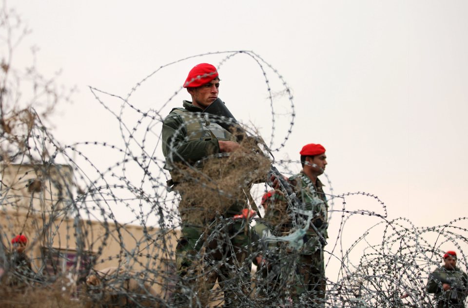  Members of the Afghan security services standing guard on a roadside amid intensified security following the suicide attack