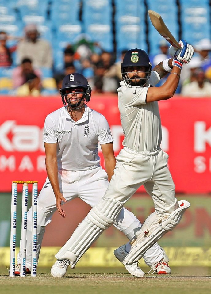 India captain Virat Kohli plays a shot as England counterpart Alastair Cook looks on