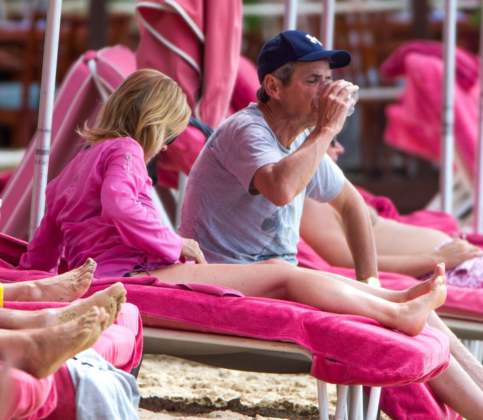  Alan Hansen quenched his thirst as he and his wife Janet relax on the beach 