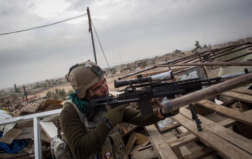  A sniper from the Iraqi Army Armoured Ninth Division hunts for ISIS snipers