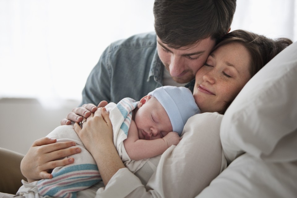 couple holding baby