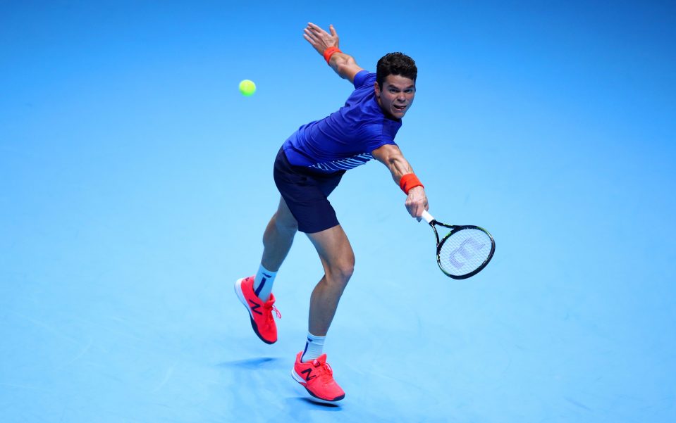 Raonic hits a backhand against Novak Djokovic 