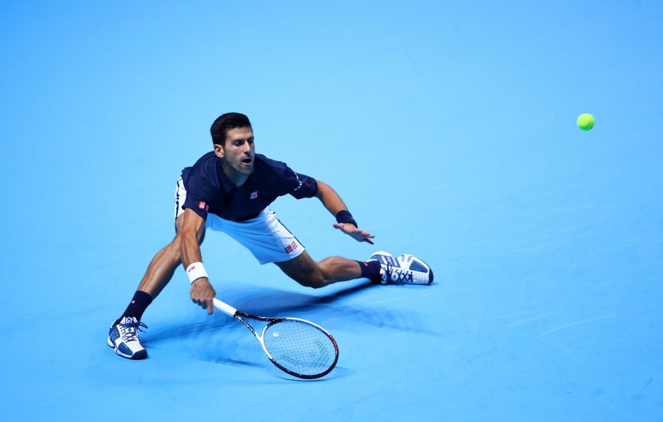 Djokovic stoops low to measure a looping shot from Raonic