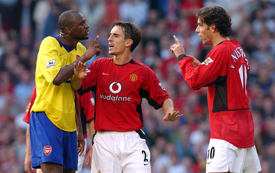 Neville grapples with Arsenal midfielder Patrick Vieira during a match in at Old Trafford in 2003