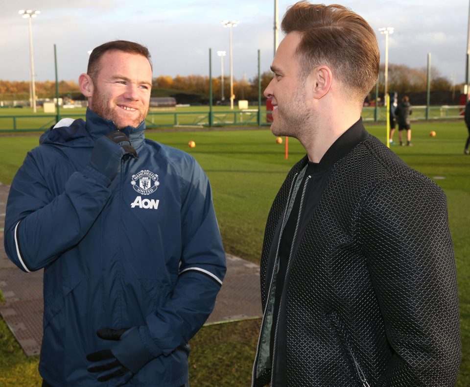 Wayne Rooney smiles as he meets Murs at United's training ground