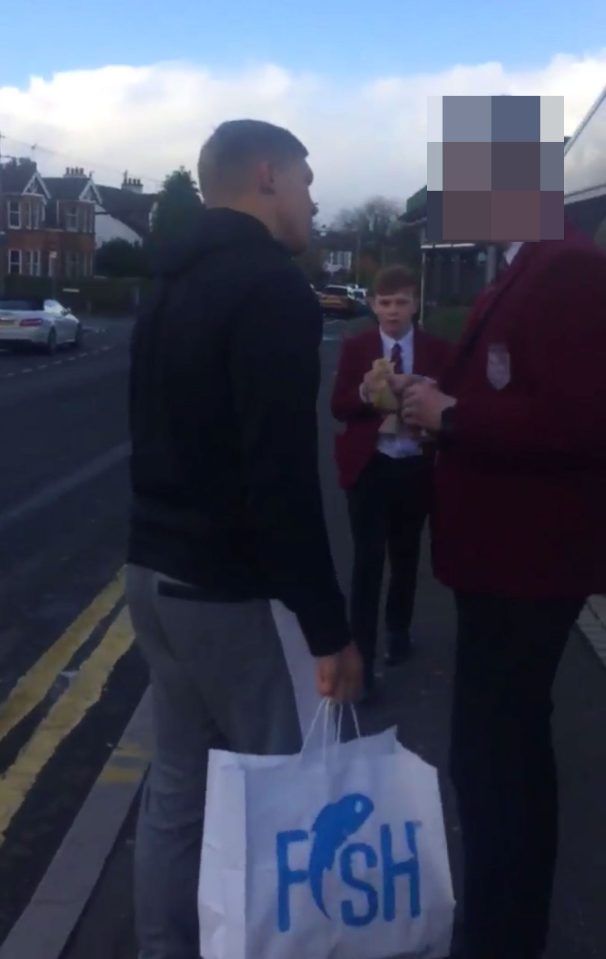  He squares up to the youngster who is wearing school uniform