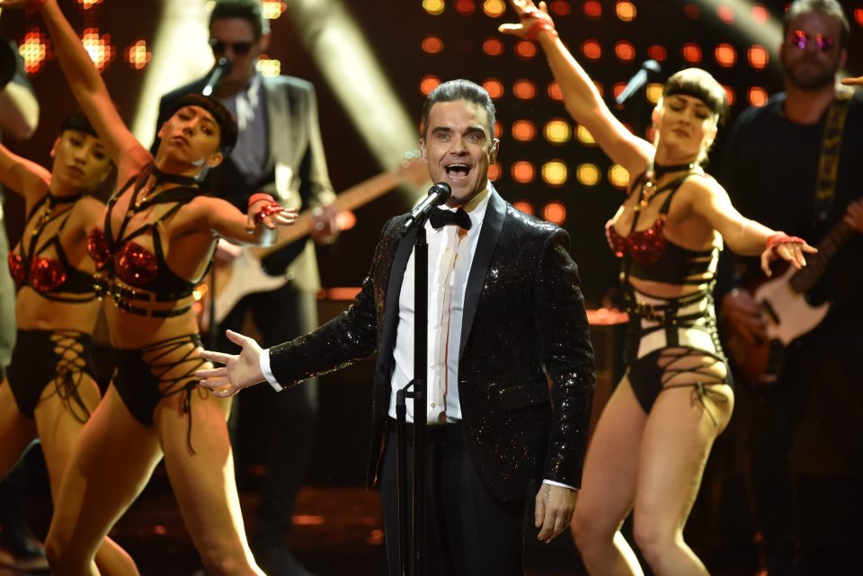  Crowd pleaser ... Robbie performing at the Bambi Awards in Berlin