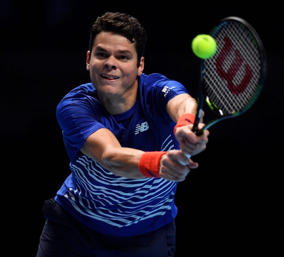 Milos Raonic powers a return against Dominic Thiem as he reaches the last four at the O2 Arena