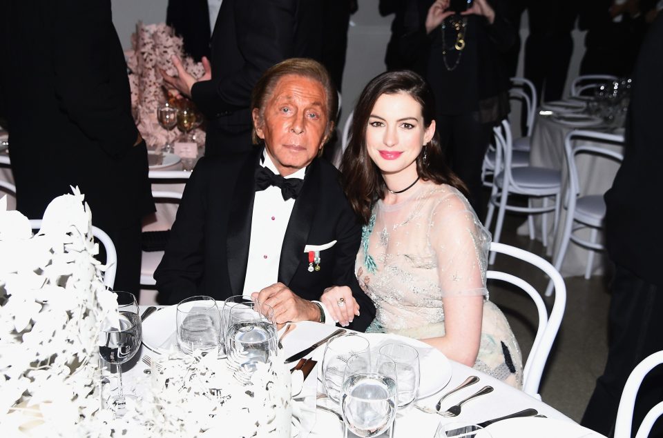 Valentino shared a table with pale beauty Anne Hathaway