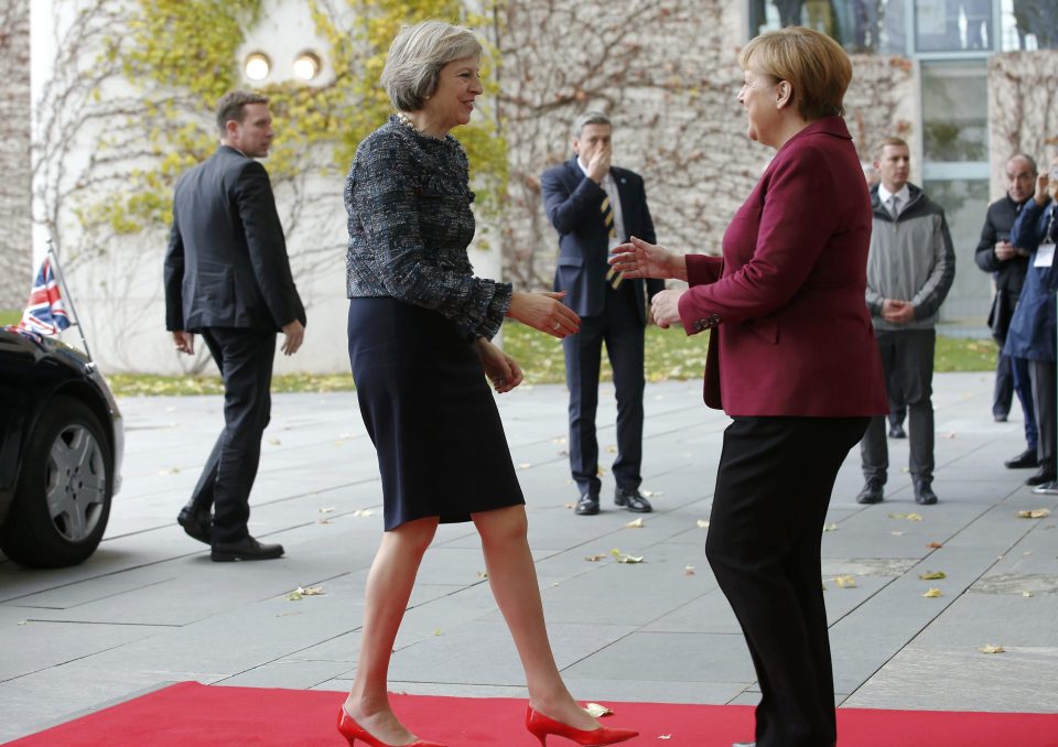  Hug or handshake? The German and UK leaders greet each other in Berlin