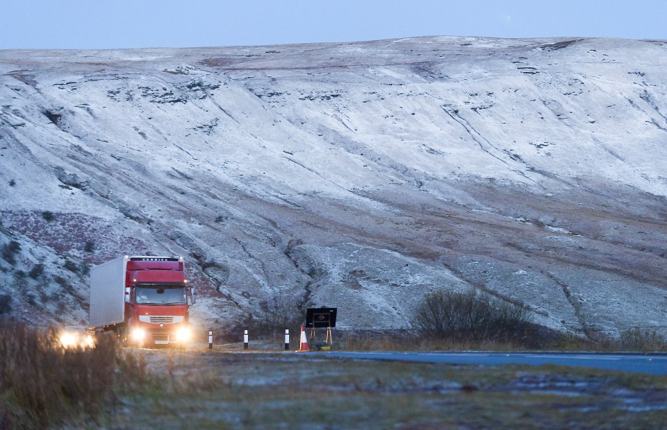  A lorry drives through a valley in the Brecon Beacons, Wales as it became another part of the country to receive a dusting