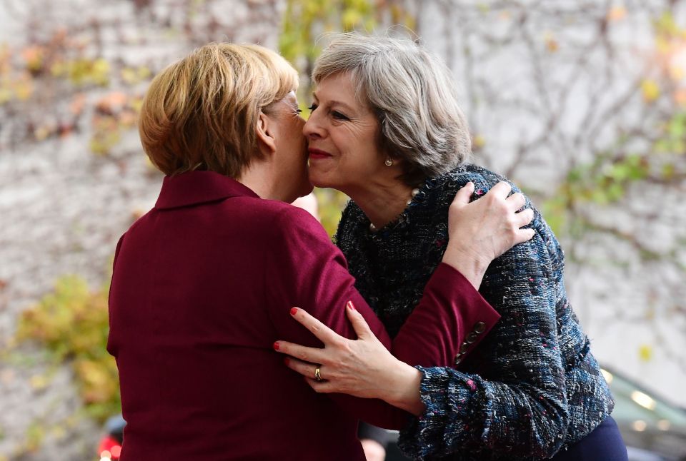  All smiles: The PM and German Chancellor greet each other in Berlin