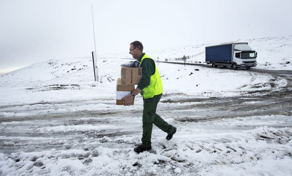 Delivery driver braves the icy conditions to make a drop off at a pub in North Yorkshire