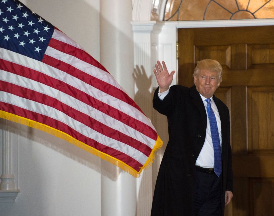  President-elect Donald Trump waves to the media from the steps at the clubhouse of Trump National Golf Club