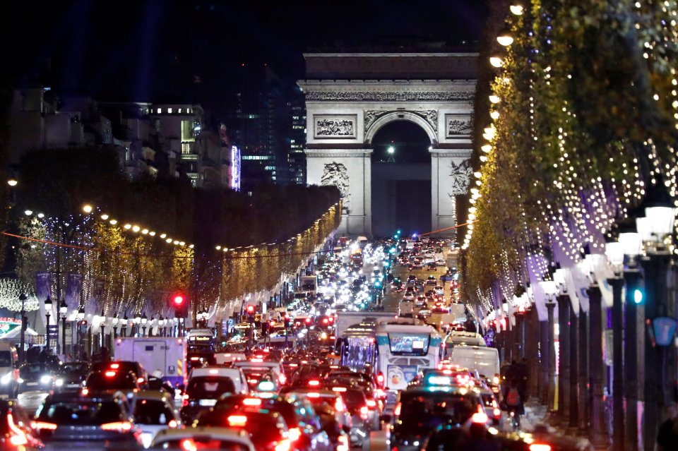  Christmas holiday lights hang from trees to illuminate the Champs Elysees avenue