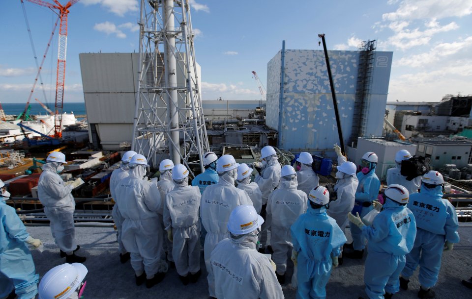 Members of the media receive briefing from Tokyo Electric Power Co. employees at tsunami-crippled Fukushima Daiichi nuclear power plant in Okuma town, Fukushima prefecture