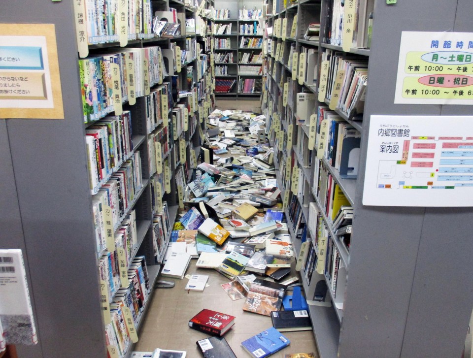 Books are scattered on the floor at a library in Iwaki, Fukushima 