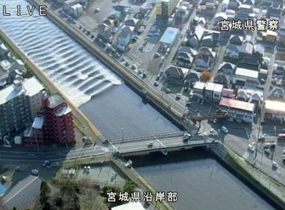 A tidal surge is seen in Sunaoshi River after tsunami advisories were issued following an earthquake in Tagajo, Miyagi prefecture