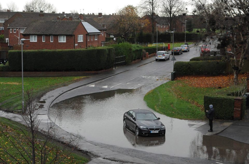 A stranded BMW taxi on Grange Road in Gateshead this morning after it broke down driving through the floods last night