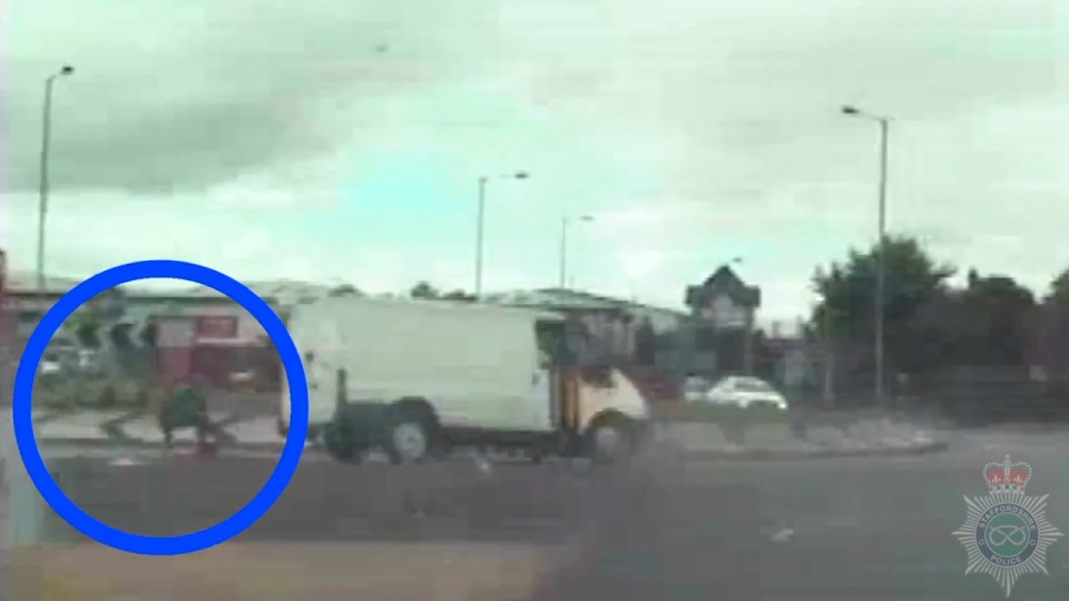 The thief can be seen falling out of the van during the police chase