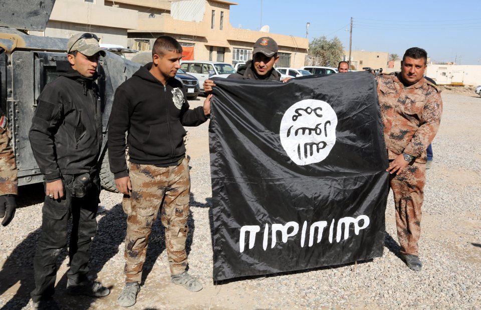  Iraqi Army Special soldiers hold a flag captured from the Islamic State