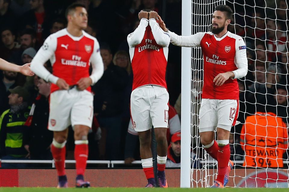 Alex Iwobi is consoled by team-mates after his own goal