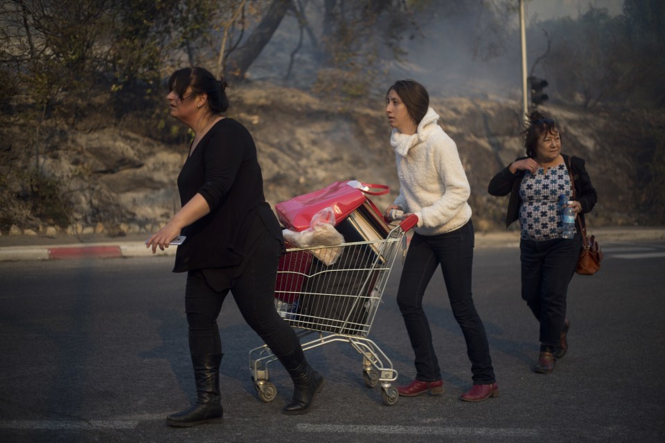  Israelis leave their lives behind as fire rages on in the northern city of Haifa on Thursday