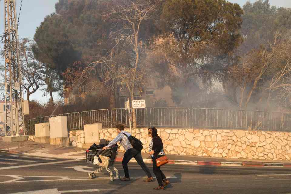  Life's belongings in a trolley ... at least 50,000 Israelis are believed to have fled their homes