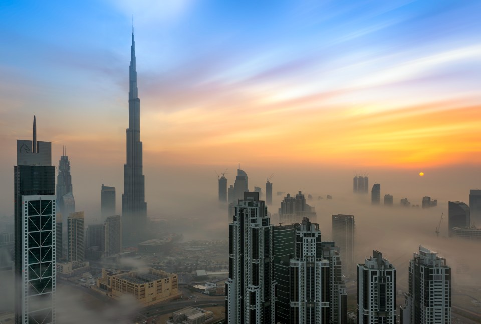 Epic... The Burj Khalifa - the world's tallest structure - rises above the clouds