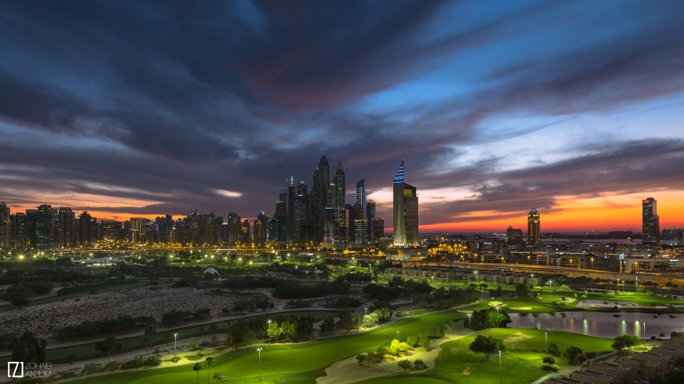 The city is lit up as ominous clouds gather above