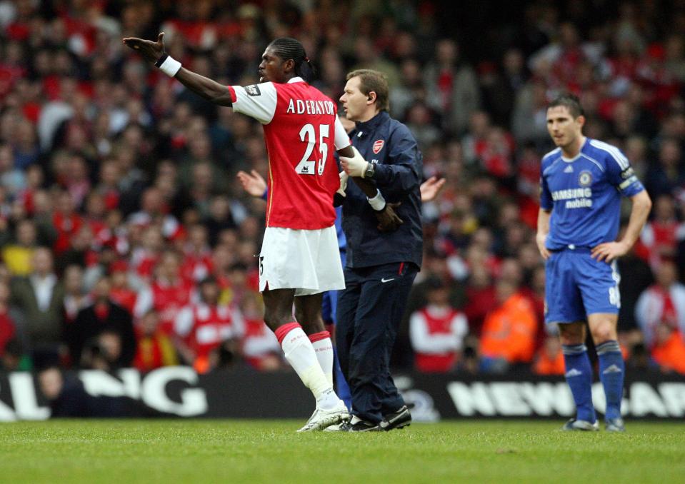  Emmanuel Adebayor is escorted from the field after being sent of in Cardiff