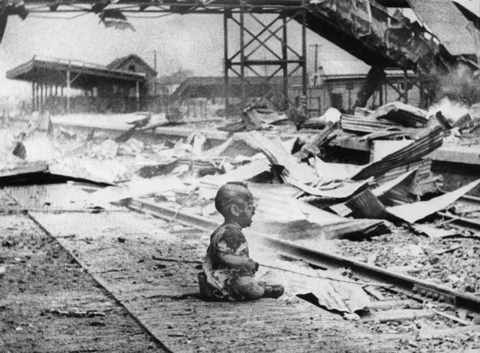 A baby cries alone in the middle of the ruins of the Shanghai train station