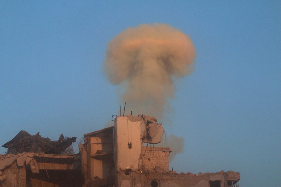  Smoke rises from a damaged building after a strike on a rebel-held besieged neighbourhood of Aleppo, Syria