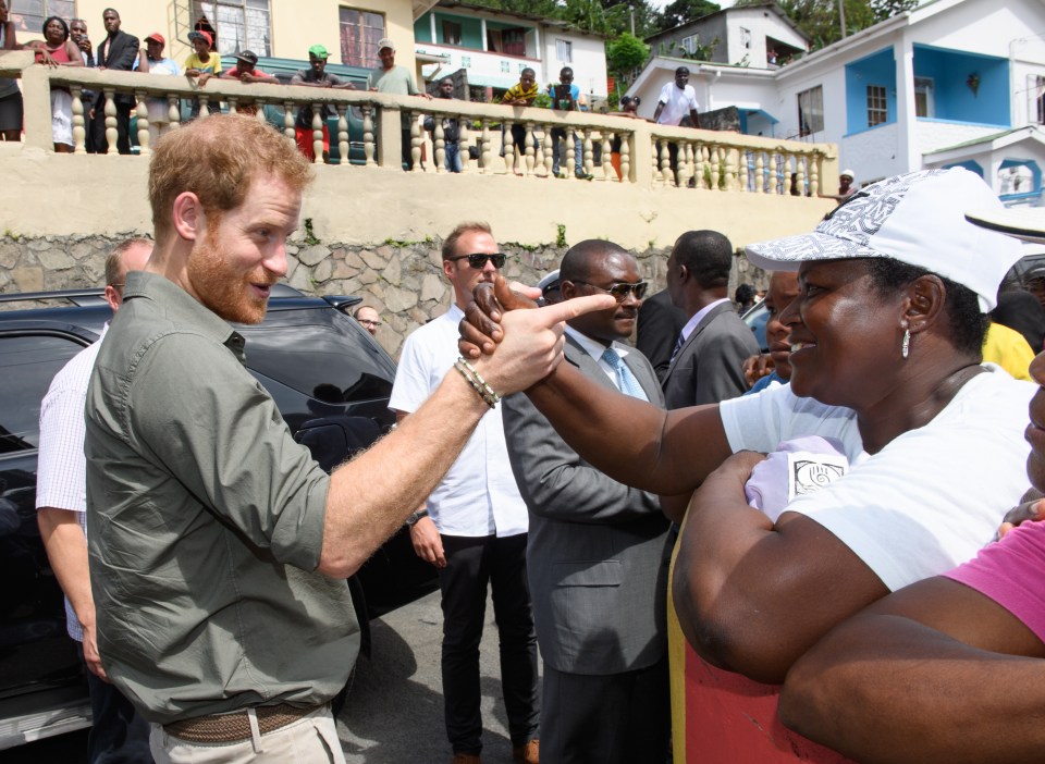  Harry tenderly held the 54-year-old's hand during the impromptu visit, which saw starstruck locals come out in droves to catch a glimpse of the Prince