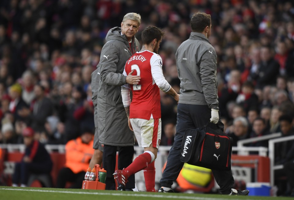 Britain Football Soccer - Arsenal v AFC Bournemouth - Premier League - Emirates Stadium - 27/11/16 Arsenal's Mathieu Debuchy with Arsenal manager Arsene Wenger as he goes off injured Action Images via Reuters / Tony O'Brien Livepic EDITORIAL USE ONLY. No use with unauthorized audio, video, data, fixture lists, club/league logos or "live" services. Online in-match use limited to 45 images, no video emulation. No use in betting, games or single club/league/player publications. Please contact your account representative for further details.