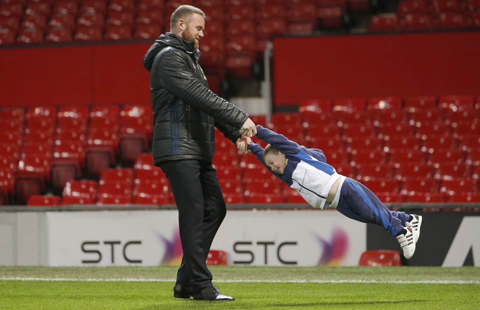  Swing when you're winning ... Wayne Rooney and son Klay enjoy some quality time at Old Trafford