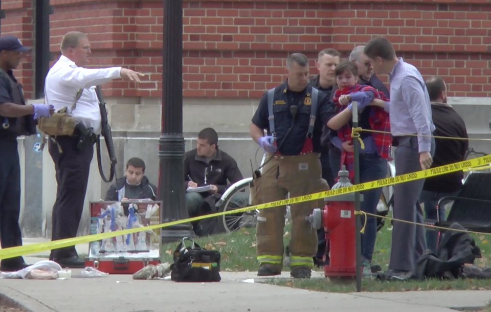  A girl is led to an ambulance by emergency personnel