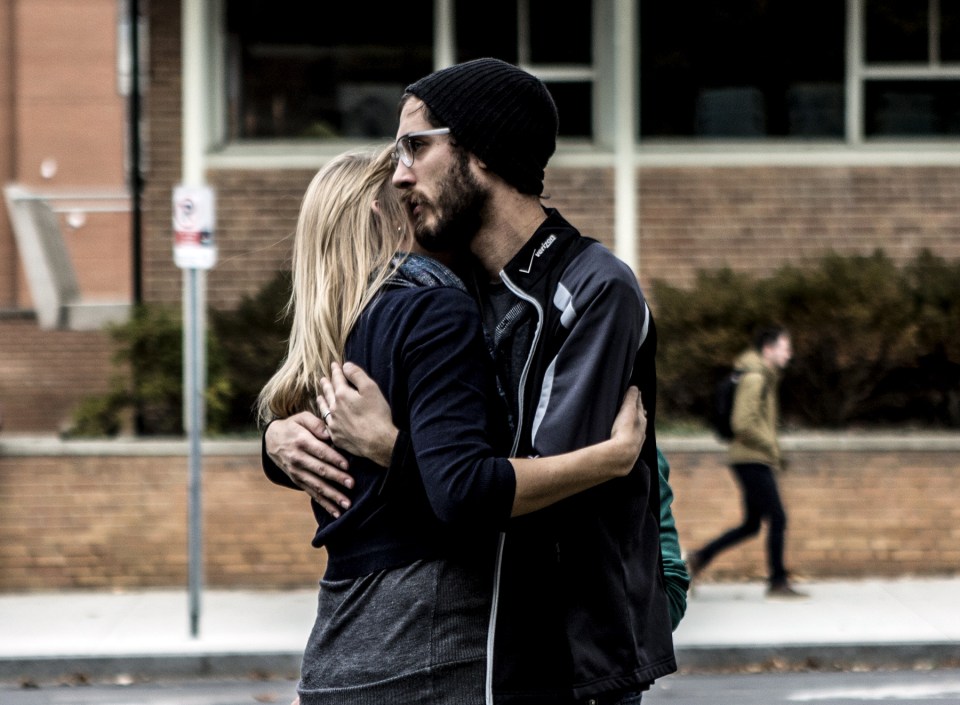  Alan Plotts embraces his wife, Elizabeth Riter, a student advisor, who was in Watts Hall on Ohio State's campus when the attack on pedestrians began