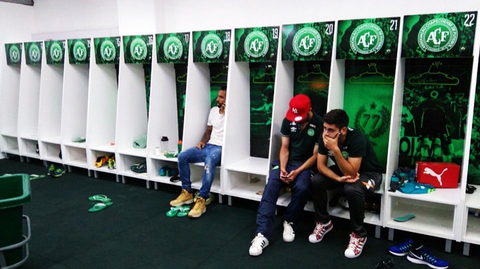 Three Chapecoense players who did not travel with the squad on the ill-fated flight sit in shock in the club’s dressing room