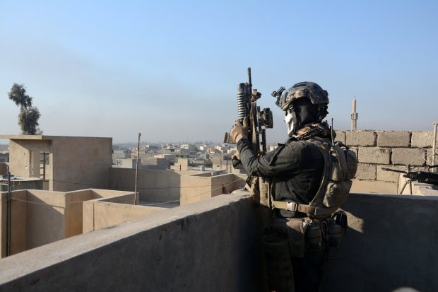 Members of the Iraqi Special Operations Forces (ISOF) take position during a battle with Isis