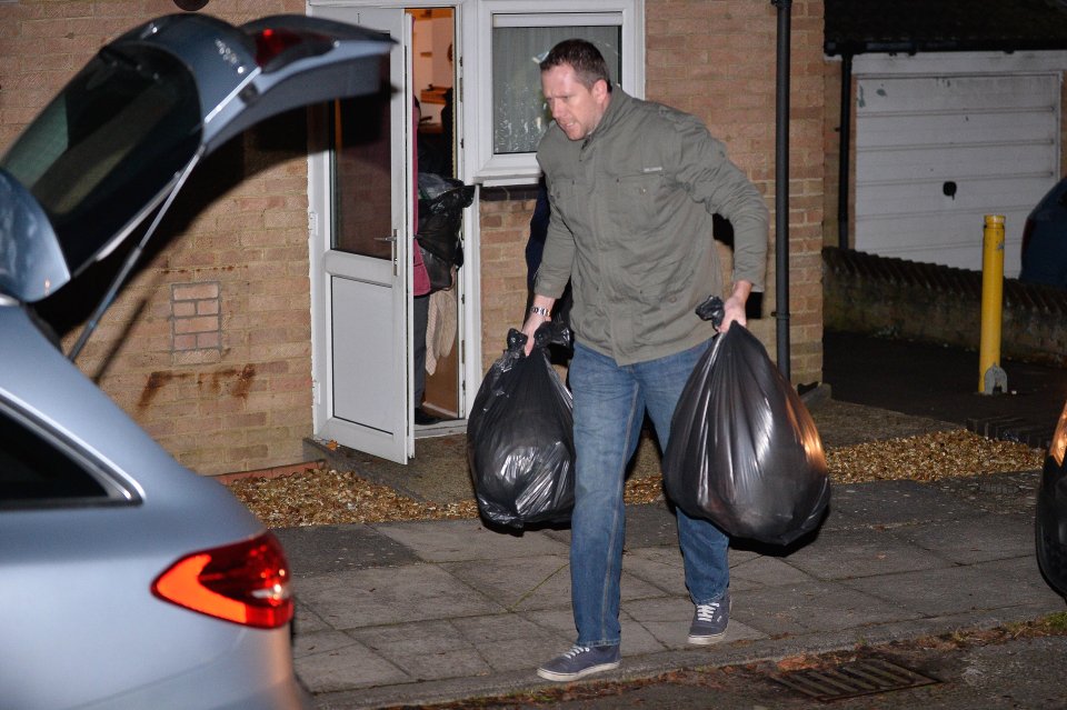 Officers carry evidence from Bennell's home following the charges