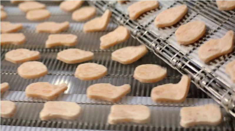  This shot of the production line clearly shows the chicken having been cut into the four shapes