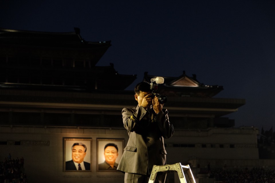  A state photographer plys his trade on Kim Il-sung Square in Pyongyang