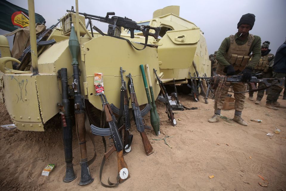  Weapons lined up against military vehicles south of Tal Afar