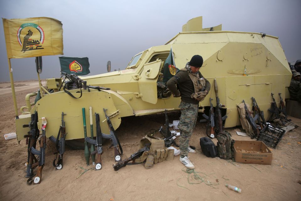  A fighter shows off his weapons during the broad offensive by Iraq forces to retake the city Mosul from Islamic State