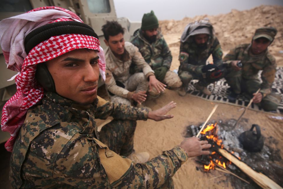  Shiite fighters take a break as they continue their advance towards Islamic State militants