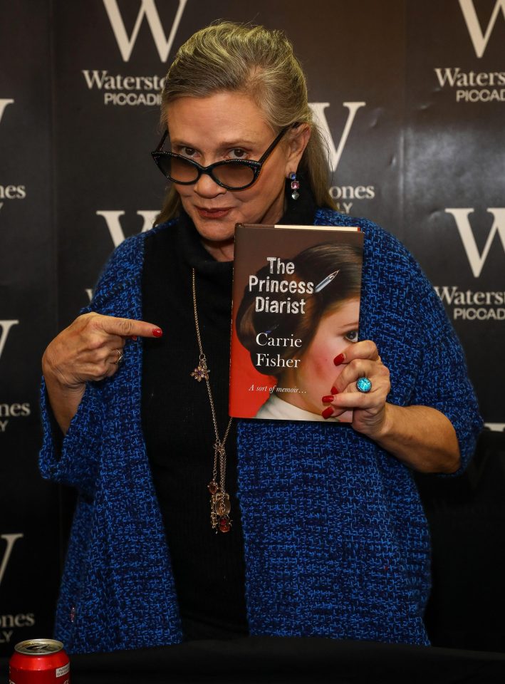  Carrie Fisher pictured greeting fans at a book signing in a London Waterstones less than three weeks before her death