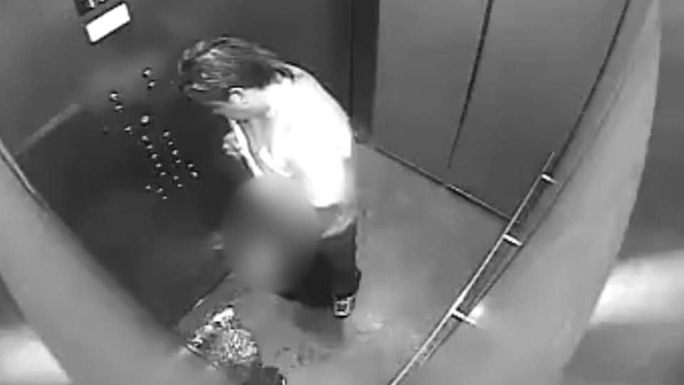  A large puddle rapidly spreads, forcing the man to move back to avoid standing in it