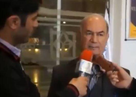 Bahram Afsharzadeh responds to a question while being interviewed by the press