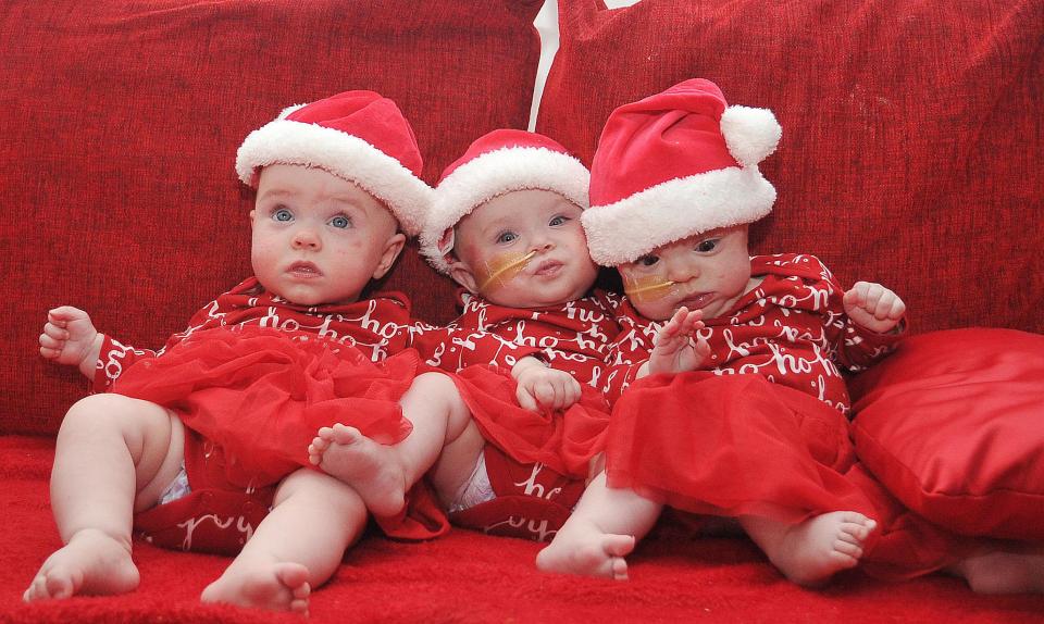  Poppie, Mollie and Evelyn dressed festive clothes for their first Christmas